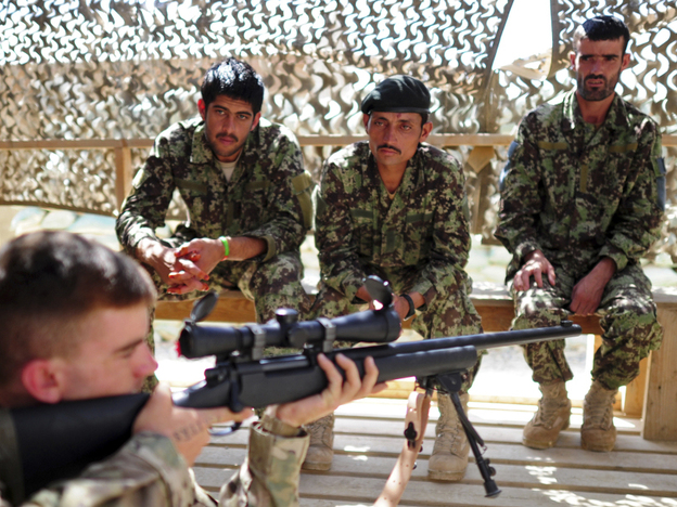 A U.S. soldier with a sniper rifle provides instruction to Afghan troops in the eastern province of Paktika last September.