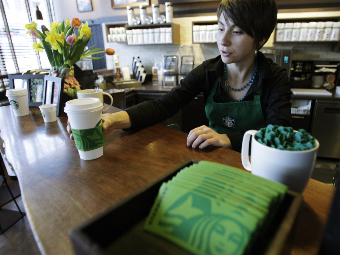 Barista Nicole Adams serves up a drink in March at a Starbucks in downtown Seattle. The company is expanding its coffee options to include a light roast and plans to create a new health and wellness brand.