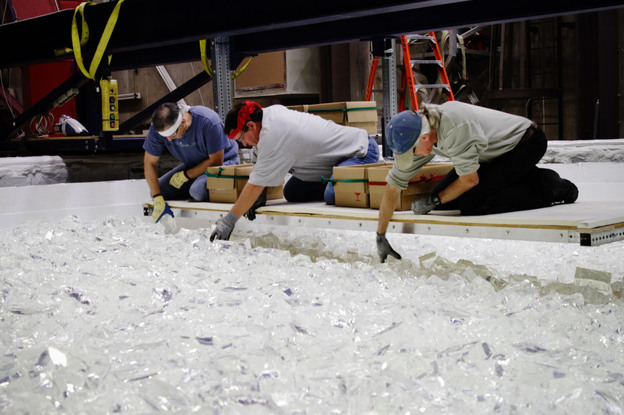 The pieces of glass that technicians are arranging inside the rotating oven will melt down into the curved surface of the telescope mirror. Each piece of glass is hand-inspected.
