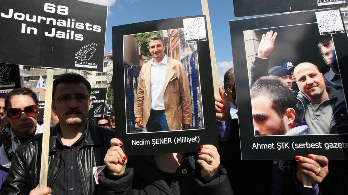 Hundreds of journalists protest the arrests of members of the media, including Ahmet Sik (poster on the right) and Nedim Sener (center) in Ankara, Turkey, in March 2011. Critics say the government is trying to stifle dissent by arresting journalists — for doing their job.