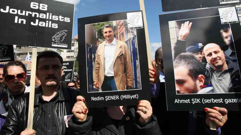 Hundreds of journalists protest the arrests of members of the media, including Ahmet Sik (poster on the right) and Nedim Sener (center) in Ankara, Turkey, in March 2011. Critics say the government is trying to stifle dissent by arresting journalists — for doing their job.