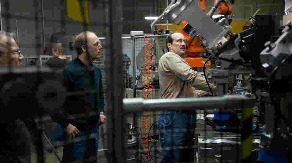 Tom Fitzgerald (left) and Shawn Dietel (center) look on as Richard Dietel operates a machine at Keen's shoe factory in Portland, Ore. The 15,000-square-foot facility houses two production lines. Tom Fitzgerald (left) and Shawn Dietel (center) look on as Richard Dietel operates a machine at Keen's shoe factory in Portland, Ore. The 15,000-square-foot facility houses two production lines.