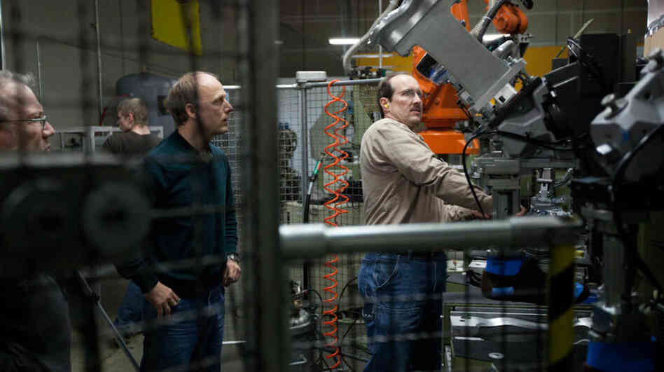 Tom Fitzgerald (left) and Shawn Dietel (center) look on as Richard Dietel operates a machine at Keen's shoe factory in Portland, Ore. The 15,000-square-foot facility houses two production lines. Tom Fitzgerald (left) and Shawn Dietel (center) look on as Richard Dietel operates a machine at Keen's shoe factory in Portland, Ore. The 15,000-square-foot facility houses two production lines.