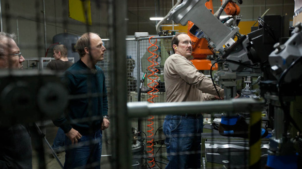 Tom Fitzgerald (left) and Shawn Dietel (center) look on as Richard Dietel operates a machine at Keen's shoe factory in Portland, Ore. The 15,000-square-foot facility houses two production lines. Tom Fitzgerald (left) and Shawn Dietel (center) look on as Richard Dietel operates a machine at Keen's shoe factory in Portland, Ore. The 15,000-square-foot facility houses two production lines.