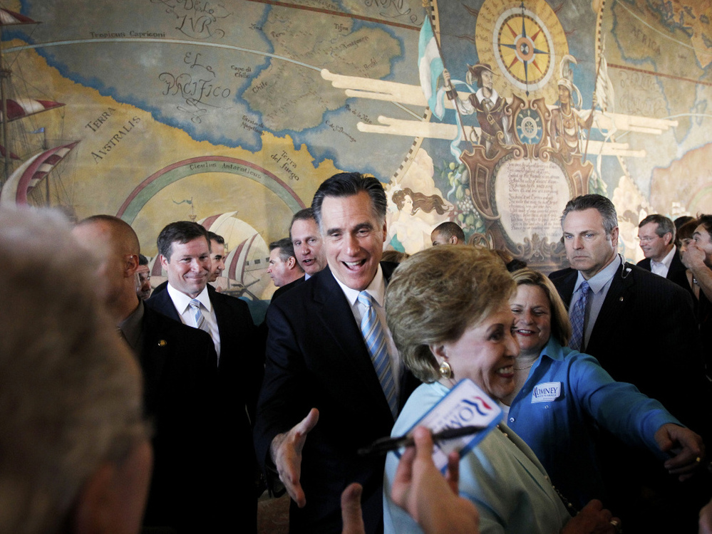 Mitt Romney, accompanied by Rep. Ileana Ros-Lehtinen, R-Fla. (third from right), campaigns Wednesday at a U.S.-Cuba Democracy Political Action Committee event at Miami-Dade College in Miami.