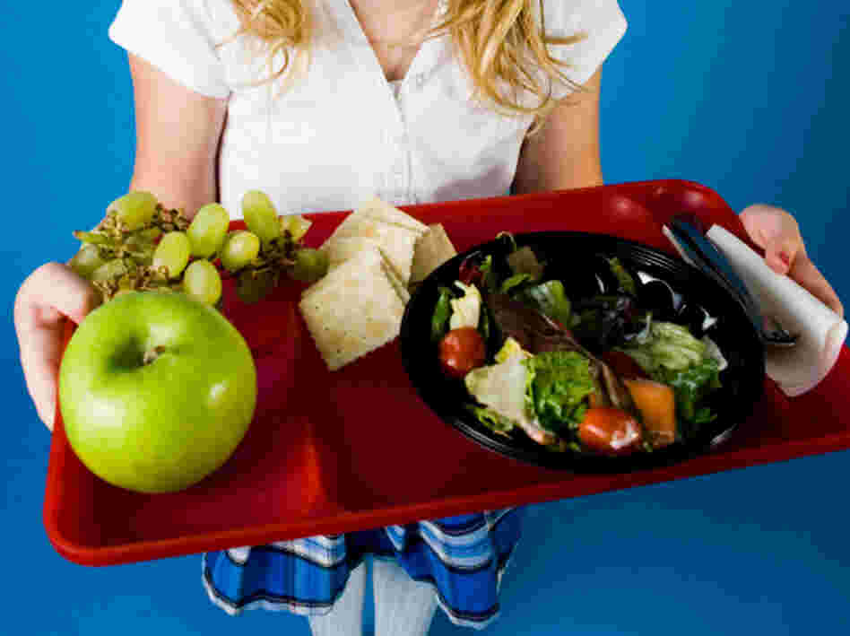 The new nutrition standards will replace school lunch dishes like pizza sticks with salad.