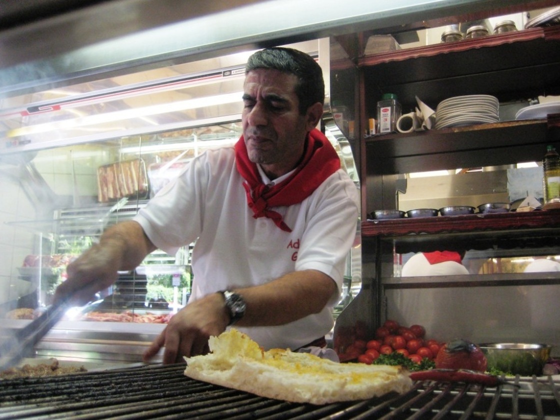 A cook at Adana Grill Haus grills adana kebab and kuzu pirzola. Cevat Akpolat, the owner of Adana Grill Haus in Kreuzberg, says his restaurant is more than just Turkish snacks. "This is a Turkish culture restaurant."