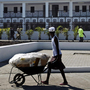 A worker pushes a wheelbarrow past the new National Teaching Hospital in Mirebalais, Haiti, on Jan. 10. When it opens this summer, the 320-bed facility will be Haiti's largest hospital and provide services and a level of care well beyond what's currently available. A worker pushes a wheelbarrow past the new National Teaching Hospital in Mirebalais, Haiti, on Jan. 10. When it opens this summer, the 320-bed facility will be Haiti's largest hospital and provide services and a level of care well beyond what's currently available.