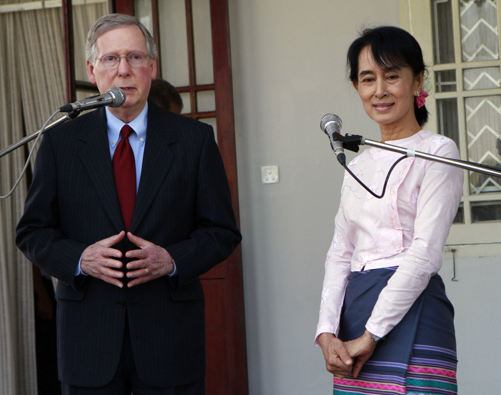 U.S. Senator Mitch McConnell talks as Myanmar pro-democracy leader Aung San Suu Kyi listens during a press conference after their meeting at her home in Yangon, Myanmar on Monday.