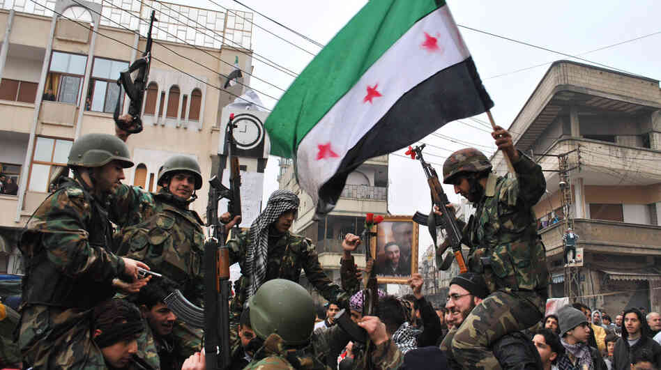Syrian army defectors wave the Syrian revolution flag Thursday, shortly after they defected to join the anti-regime protesters. Syrian army defectors wave the Syrian revolution flag Thursday, shortly after they defected to join the anti-regime protesters.