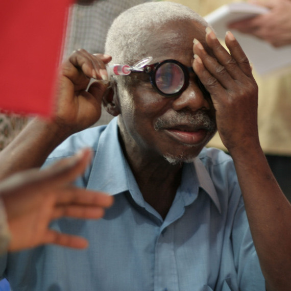 A man from Liberia uses a pump to adjust his liquid silicon lens. Liquid-lens glasses are part of an effort to make eyewear more accessible in the developing world.
