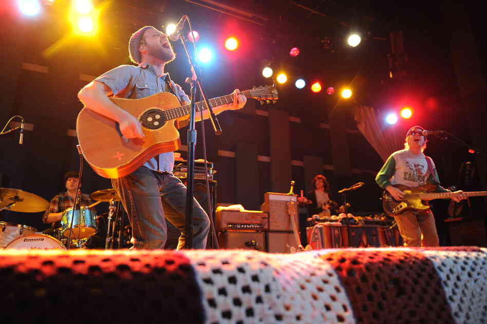 Toby Leaman (left, front) picks up an acoustic guitar while performing with Dr. Dog.
