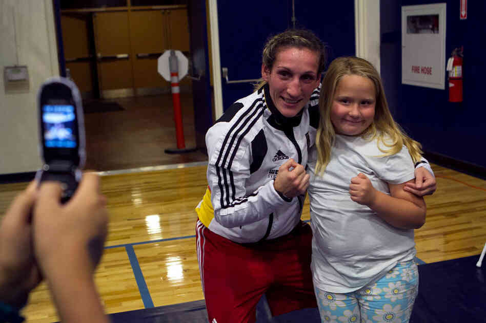 Julia Irman won the German National Championship three weeks after giving birth to her son. Here, she poses with a young fan. "In a couple years, I want to have another child. A girl. A boxer like me."