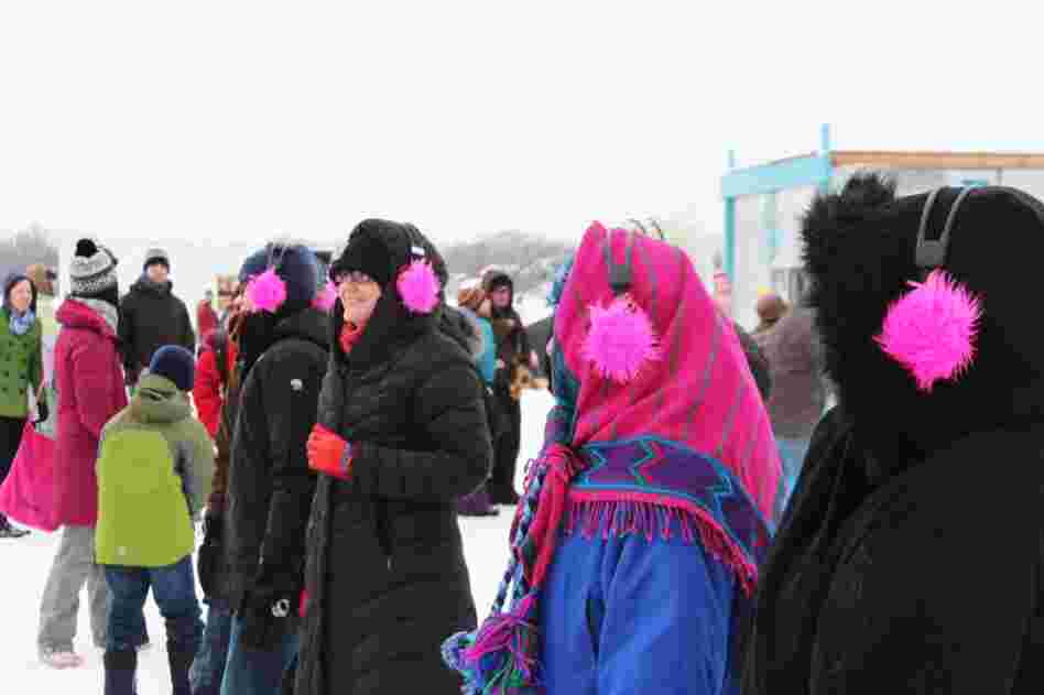 Festival attendees listen to a tour from the Audio Adventure Shanty through headphones that double as another layer of insulation.