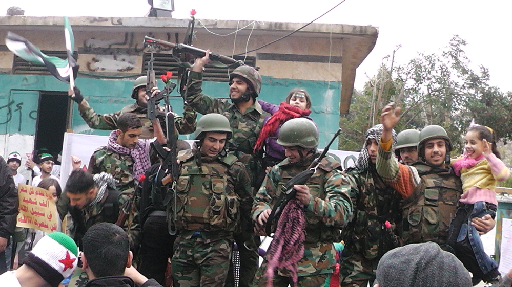Syrian soldiers who defected join protesters in the al-Khaldiya neighborhood of the restive city of Homs on January 26, 2012.