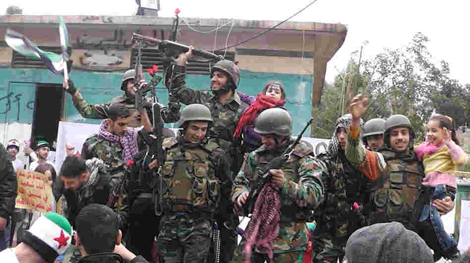 Syrian soldiers who defected join protesters in the al-Khaldiya neighborhood of the restive city of Homs on January 26, 2012.