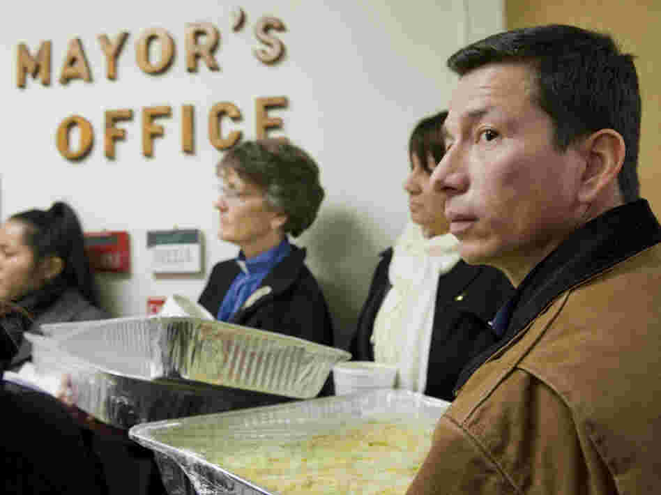 Dixon Jimenez (right), delivers tacos with other activists to Mayor Joseph Maturo Jr. in East Haven, Conn., on Jan. 26. Maturo was not in his office to receive the tacos. 