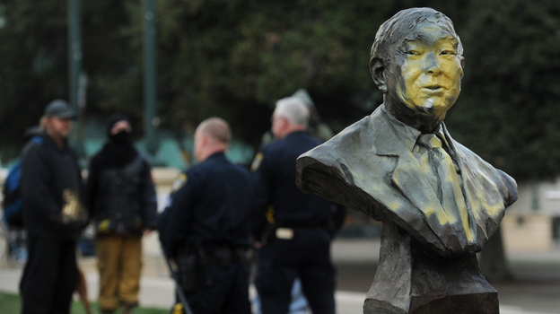 A defaced bust of former city councilmember Frank Ogawa sits outside Oakland, Calif., City Hall on Sunday.