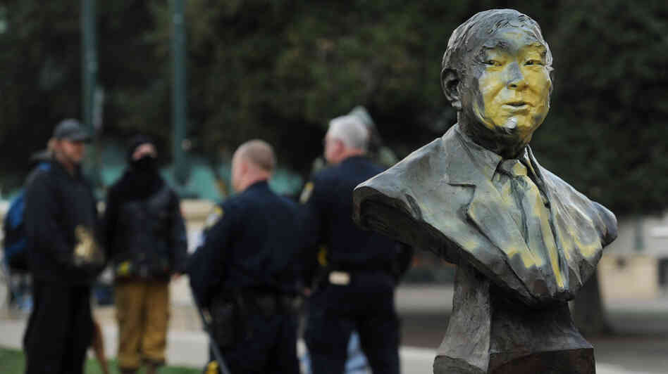 A defaced bust of former city councilmember Frank Ogawa sits outside Oakland, Calif., City Hall on Sunday.