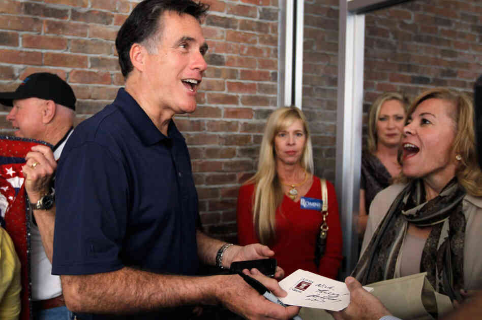 Romney greets supporters during a visit to his headquarters in Tampa. 