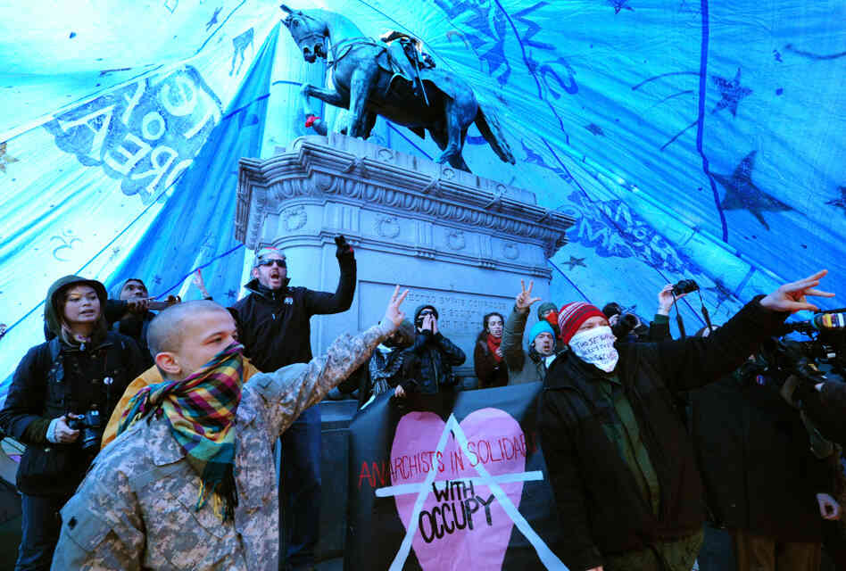 Occupy D.C. protesters shout slogans after erecting a tent over the statue of Civil War Maj. Gen. James Birdseye McPherson at McPherson Square in Washington.