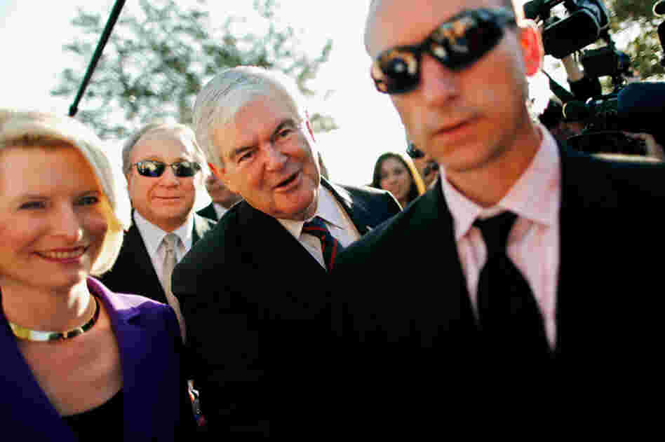 Newt and Callista Gingrich walk ahead of Michael Reagan (second from left), son of former President Ronald Reagan, outside a polling place in Windermere. 