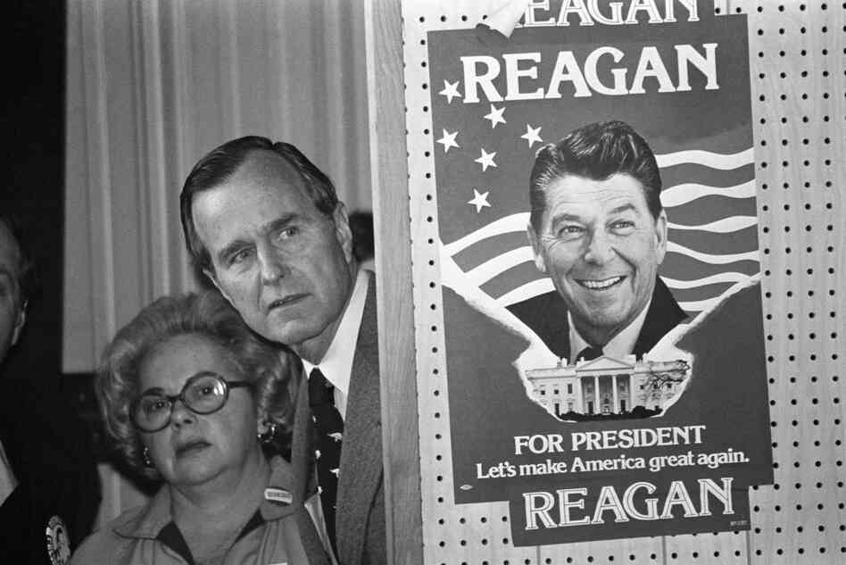 George H.W. Bush lit into what he dubbed Ronald Reagan's "voodoo economics" when the two competed for the 1980 GOP nomination. Bush peeks around a partition which has a poster of Reagan before he speaks in Columbia, S.C., March 4, 1980. 