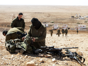 Israeli army snipers pack their gear after an army exercise at the Shizafon army base, in the Negev Desert north of the southern city of Eilat, on Tuesday. Israeli army snipers pack their gear after an army exercise at the Shizafon army base, in the Negev Desert north of the southern city of Eilat, on Tuesday.