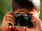A boy takes a photo. A boy takes a photo.