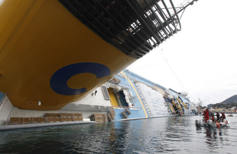 Italian firefighters scuba divers approach the grounded cruise ship Costa Concordia off the Tuscan island of Giglio, Italy on Friday. Italian firefighters scuba divers approach the grounded cruise ship Costa Concordia off the Tuscan island of Giglio, Italy on Friday.