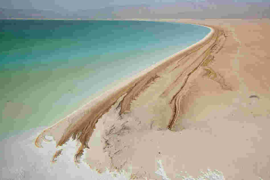 Djibouti's Lake Assal is one of the world's saltiest lakes. Intense heat and strong winds fuel rapid evaporation, leaving a bathtub ring of minerals around the lake's shore.