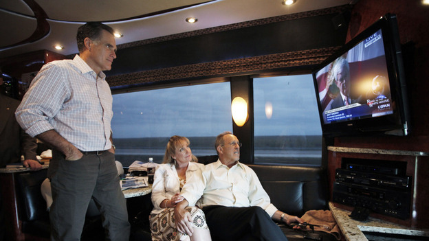 Mitt Romney watches his GOP rival Newt Gingrich on TV as he rides his campaign bus on Sunday with his brother Scott and sister-in-law Sheri. Using the power of television — through ads and debates — was a key part of Romney's strategy in Florida.