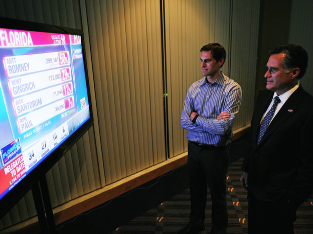 Mitt Romney watches primary election results with his son Josh in Tampa on Tuesday night. He won in Florida by the same margin he lost by in South Carolina. 