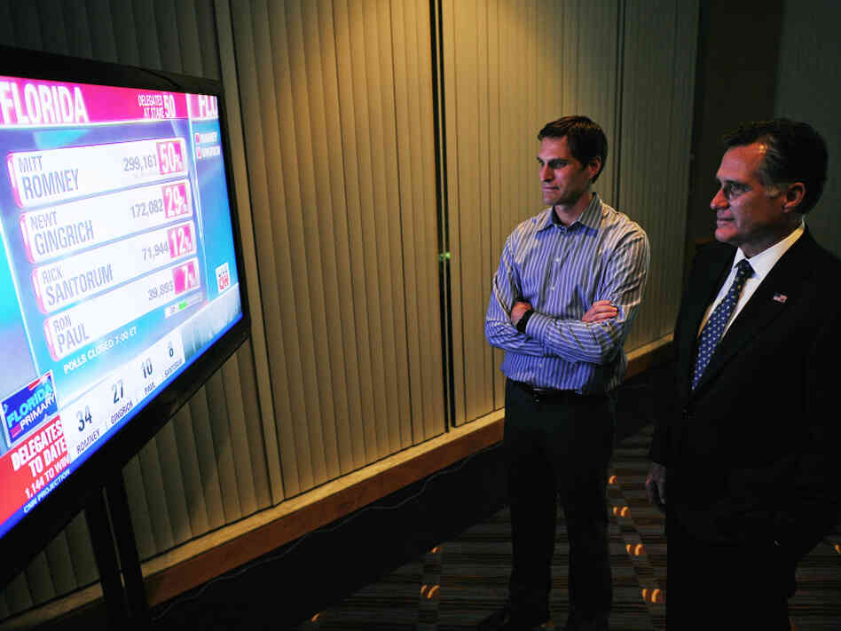 Mitt Romney watches primary election results with his son Josh in Tampa on Tuesday night. He won in Florida by the same margin he lost by in South Carolina. 