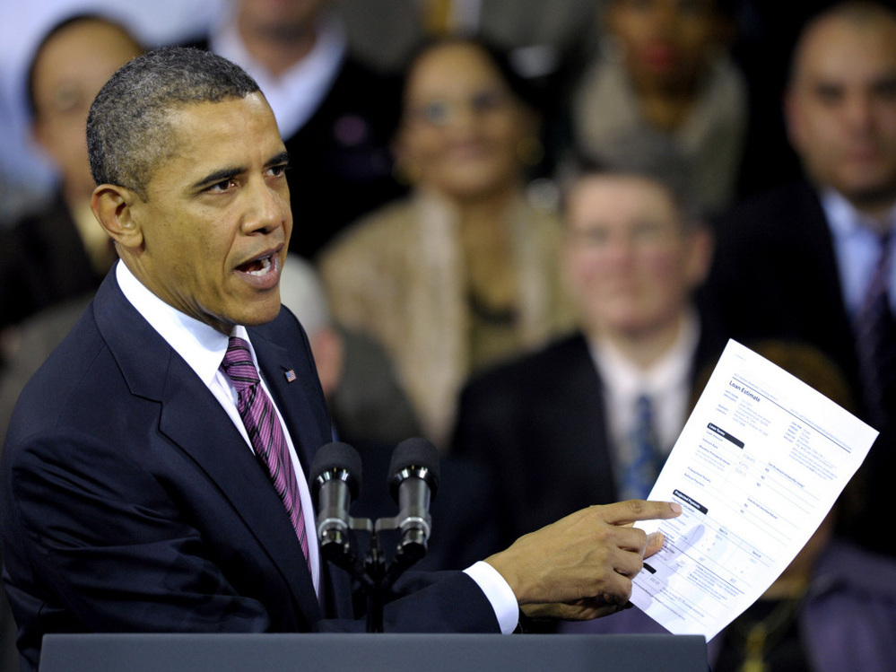 President Obama holds a proposed mortgage application in Falls Church, Va., Wednesday, Feb. 1, 2012. 