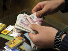 An Iranian man counts banknotes after exchanging a gold coin for cash in Tehran. An Iranian man counts banknotes after exchanging a gold coin for cash in Tehran.