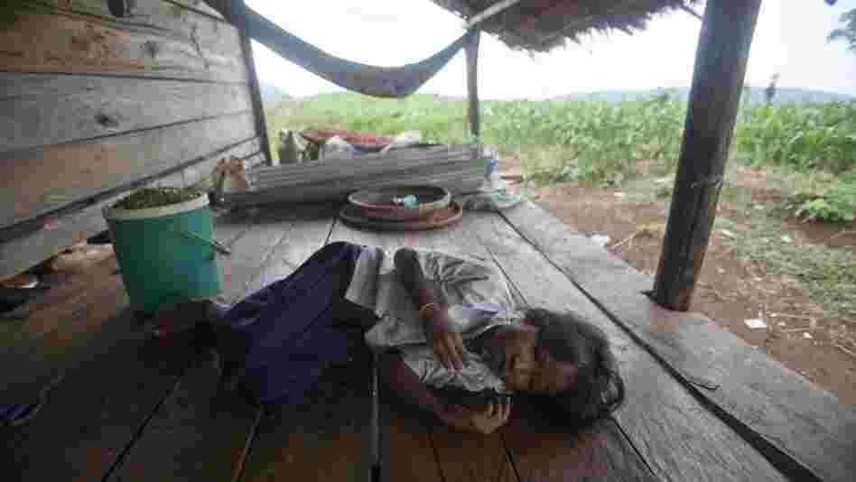 Chhay Meth, 9, suffering through an attack of malaria at the family's home in O'treng village on the outskirts of Pailin, Cambodia, in 2009. A drug-resistant form of malaria in the region medical led officials to declare a health emergency. 