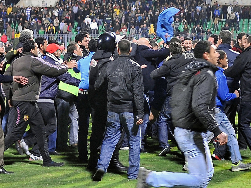 Fans rushed on to the field Wednesday after the soccer match in Port Said, Egypt. 