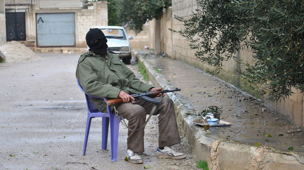 Even as the current Syrian uprising continues, some Syrians plan to mark a brutal crackdown carried out by the government 30 years ago in the central city of Hama. Here, a Syrian rebel guards an alley in the central province of Homs on Wednesday. Even as the current Syrian uprising continues, some Syrians plan to mark a brutal crackdown carried out by the government 30 years ago in the central city of Hama. Here, a Syrian rebel guards an alley in the central province of Homs on Wednesday.