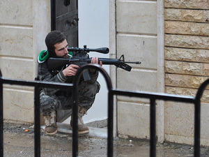 A Syrian rebel aims his weapon during a battle with the Syrian government forces at Rastan area in Homs province, central Syria, on Jan. 31. A Syrian rebel aims his weapon during a battle with the Syrian government forces at Rastan area in Homs province, central Syria, on Jan. 31.