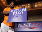 A worker mounts a sign to the podium before Republican presidential candidate Newt Gingrich's Florida Republican presidential primary night rally, Jan. 31, in Orlando, Fla. A worker mounts a sign to the podium before Republican presidential candidate Newt Gingrich's Florida Republican presidential primary night rally, Jan. 31, in Orlando, Fla.