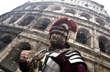 A man dressed as a Roman Centurion stands in front of the ancient Colosseum as snowflakes fall in downtown Rome on Friday. A man dressed as a Roman Centurion stands in front of the ancient Colosseum as snowflakes fall in downtown Rome on Friday.