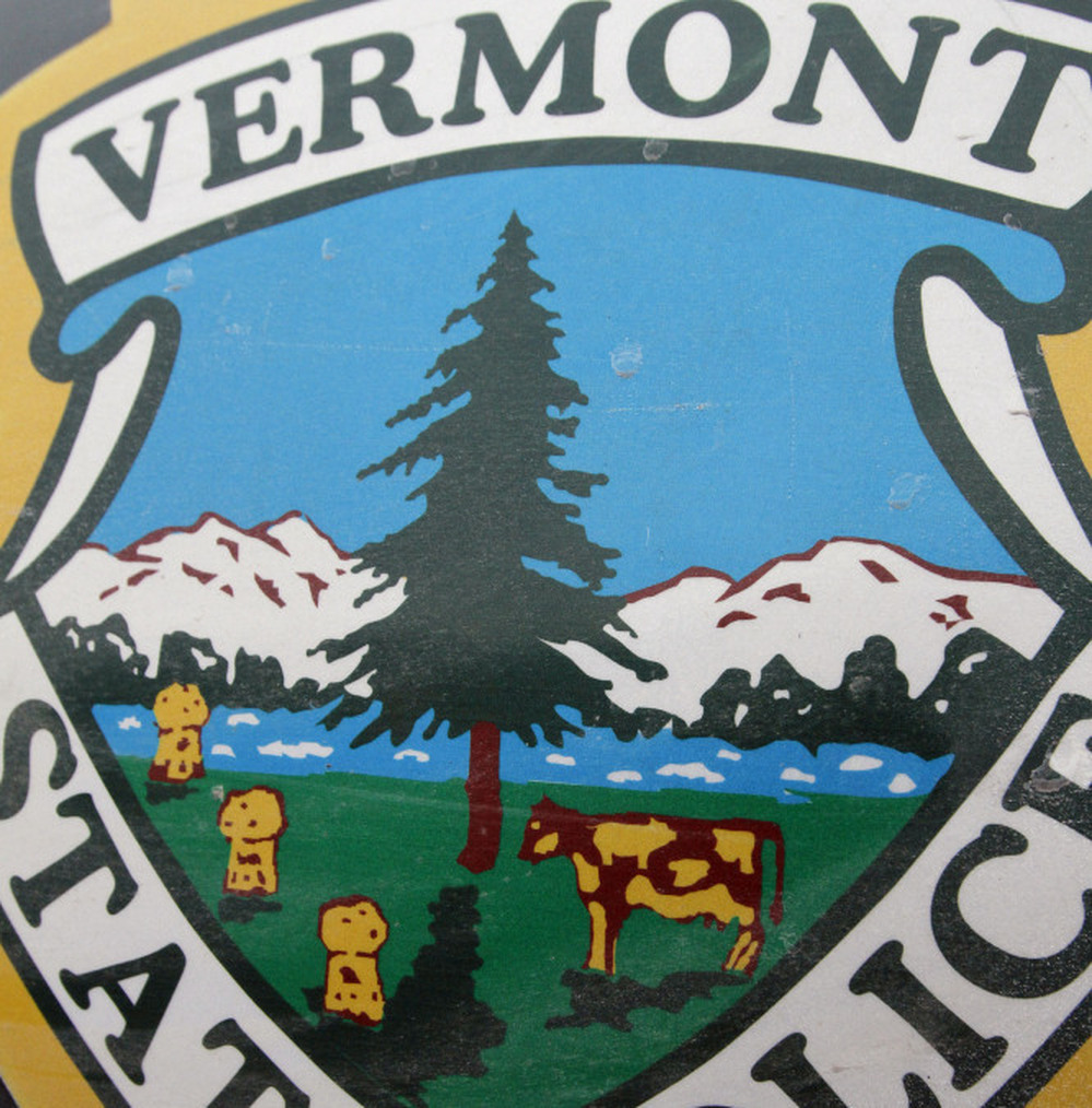 The state seal is seen on the side of a Vermont State Police cruiser. Some Vermont inmates have gotten the best of the state police by adding a pig to the state decal on their cruisers.