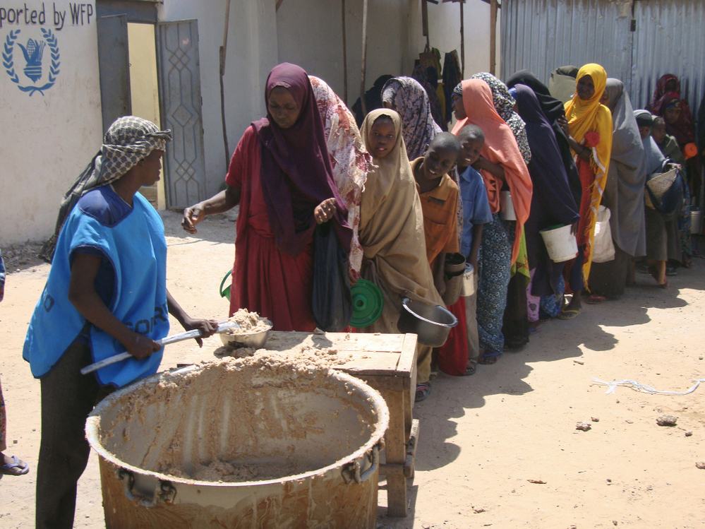 Displaced families line up to receive food rations at a feeding center in Somalia.