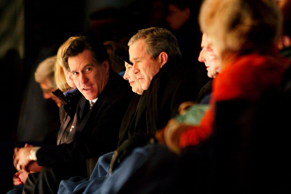 Romney chats with President George W. Bush during the Opening Ceremony at the Salt Lake City Winter Olympic Games in 2002. 