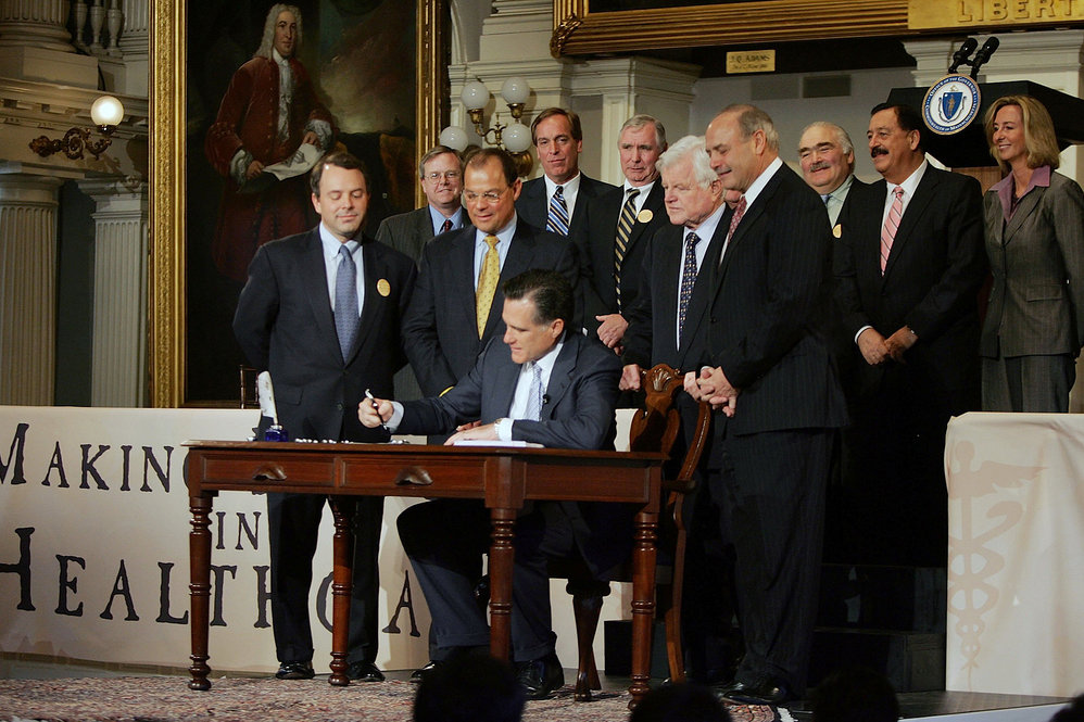Gov. Romney signs into law his landmark health care overhaul bill during a ceremony in 2006. 