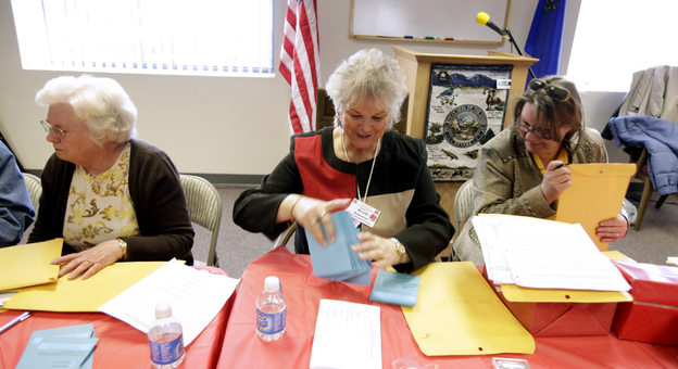 Jan White, left, Brenda Robertson, center, and Janet Freixas, right, count paper ballots at the headquarters of the Douglas County Republican Party Saturday in Minden, Nev., following county-wide Nevada caucus meetings.