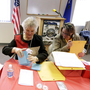 Jan White, left, Brenda Robertson, center, and Janet Freixas, right, count paper ballots at the headquarters of the Douglas County Republican Party Saturday in Minden, Nev., following county-wide Nevada caucus meetings.