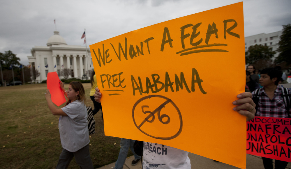 Protestors march outside the Alabama Capitol during a demonstration against Alabama's immigration law in Montgomery, Ala. on Nov. 15, 2011. 