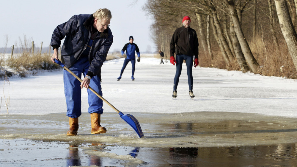 Volunteer Sjoerd Swart shovels away snow from the ice in Oudemirdum, Netherlands, in hopes the Elfstedentocht, or 11 Cities Tour, may be held for the first time in 15 years. 